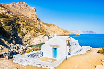 White Greek chapel on rock cliff near Agia Anna beach, Amorgos island, Cyclades, Greece