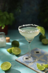 A glass with margarita cocktail with lime