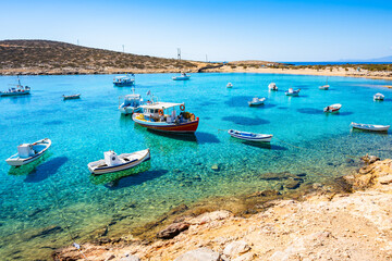 Obraz premium Boats in sea bay of Kalotaritissa with beautiful sandy beach, Amorgos island, Cyclades, Greece