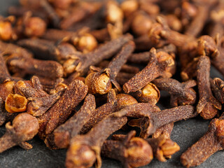 A close-up of aromatic cloves, highlighting the texture and rich color