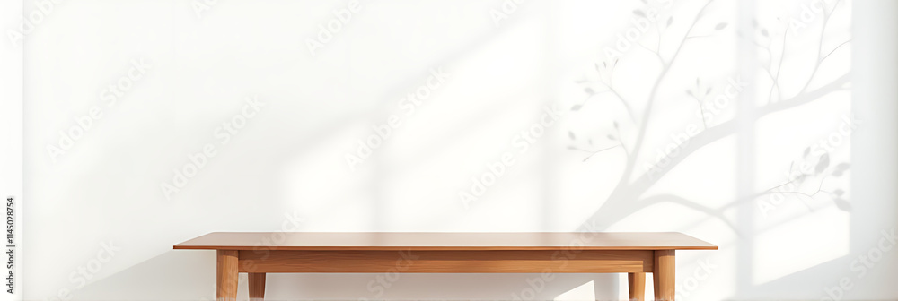 Aufkleber a minimalist wood table stands against a white wall with a natural tree leaf pattern serving as a de