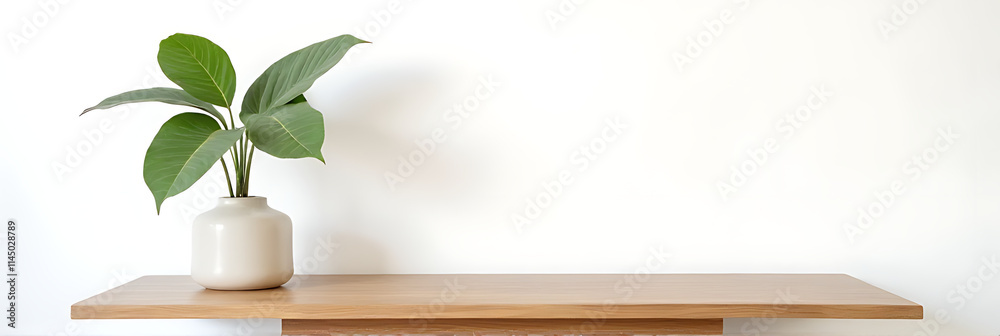 Aufkleber a minimalist wood table stands against a white wall with a natural tree leaf pattern serving as a de