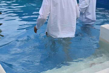 water baptism and man in white clothes,