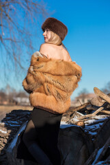 Slavic retro aesthetic. Portrait of a European type Blond head Young woman with natural skin in fur...