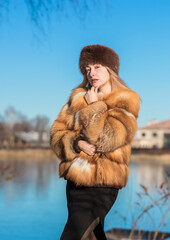 Slavic retro aesthetic. Portrait of a European type Blond head Young woman with natural skin in fur...