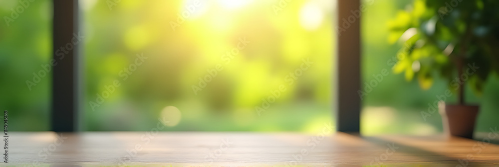 Aufkleber A blurred image of a green garden is visible through the window on an empty wooden table in the morning light._00001_