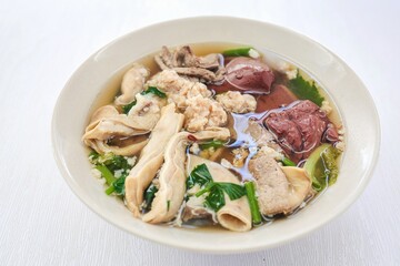 Thai Style breakfast Clear Soup with Congealed pork blood . Thai Traditional boiled soup pig blood supply on white background, 