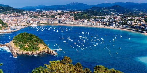 San Sebastian Spain - august 23, 2024. Santa Clara Island (L) and La Concha beach. La Concha Bay.