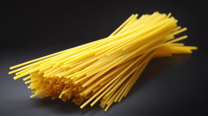 Bundle of uncooked spaghetti noodles on a dark surface.
