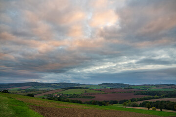 Picturesque view of the German countryside with fields, forests and cozy houses, under the sunset sky. Dresden. Germany