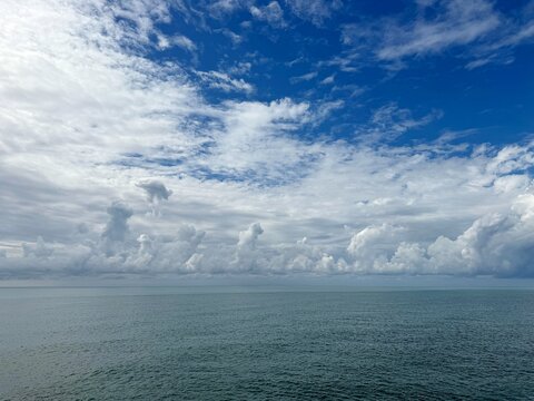 Beautiful sky clouds over calm ocean waters.