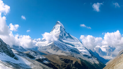 The famous Matterhorn peak under a cloudy blue sky viewed from Gornergrat, Zermatt, Switzerland.