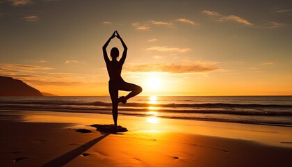 Girl practicing yoga on a rocky beach at sunrise in tree pose.