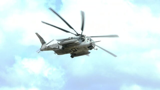 A CH-53E Super Stallion helicopter flies and banks over the Marine Corp Air Station in Beaufort, South Carolina