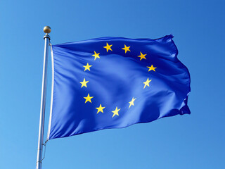 European Union flag waving against a clear blue sky with scattered clouds.