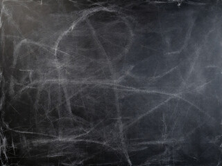 Chalkboard filled with messy chalk doodles and scribbles, evoking a classroom setting.