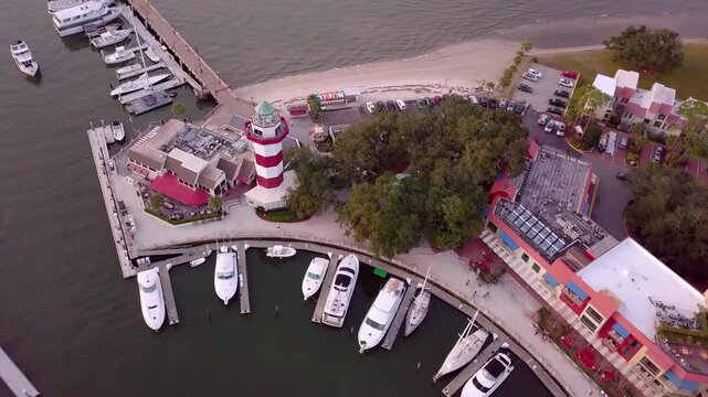 Cinematic circling view of Harbour Town, Hilton Head, South Carolina including the marina and lighthouse
