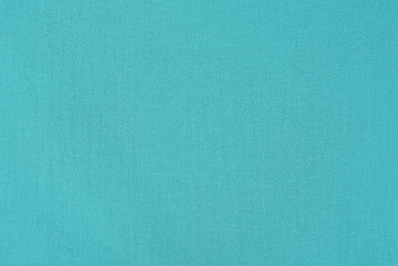 Turquoise fabric as a background. Dyed fabric macro photo.