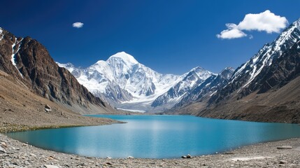 Obraz premium Turquoise Lake Nestled Among Majestic Snow Capped Mountains