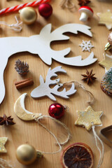Various Christmas decorations in neutral colors on wooden background. Selective focus.