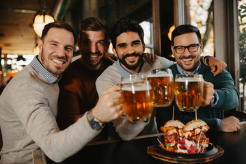 Group of friends drinking beer and have fun in beer bar