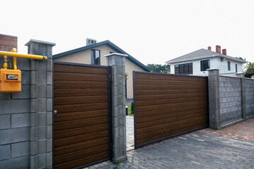 gate to the courtyard of the house. the gate is brown.