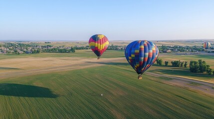 Obraz premium Hot Air Balloons Soar Over Rural Landscape