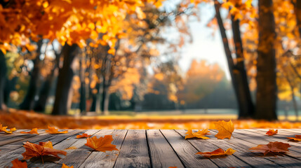 A wooden table decorated with orange leaves for an autumn ambiance.