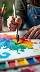 Hand painting vibrant colors on canvas