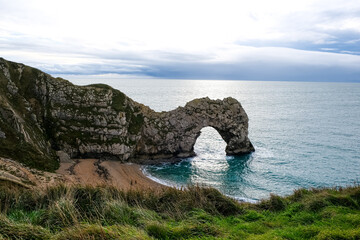 Durdle Door limestone arch on the Jurassic Coast in Dorset. Natural landmark. England. Pure clean clear water. Winter cold day at Durdle Door in Dorset, England, UK