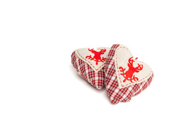 Two Christmas decorations in the shape of plush hearts with a red check. isolated on a white background