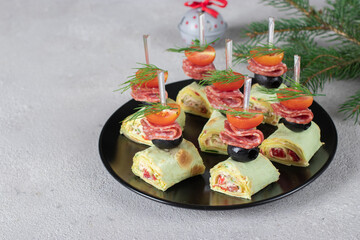 Lavash canape with sausage, olives and cherry tomatoes