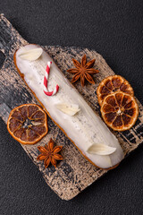 Sweet eclair with chocolate filling covered with white glaze