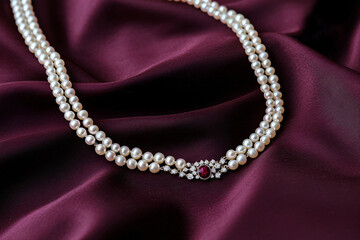 Obraz premium cultured pearl necklace cascading on deep wine-colored silk