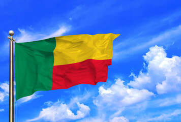 Benin National Flag Waving Against a Clear Blue Sky