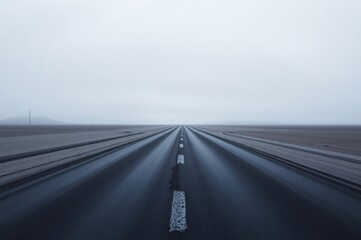 Endless Road Through a Foggy Landscape in Neutral Tones
