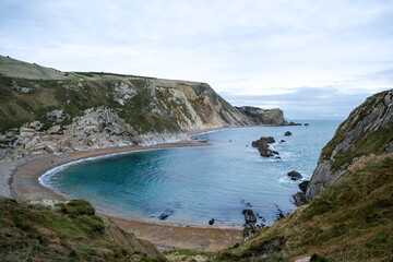 Man O'War Beach and Durdle Door on Jurassic Coast, Dorset, England. Scenic bay surrounded by Jurassic Coast rocks. Winter or autumn days. beautiful landscape and seascape view. English Channel sea vie