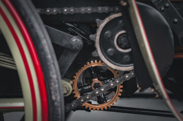 Cogs and chain of a drive mechanism on a vintage, veteran car from motor show in Brighton, East Sussex, UK