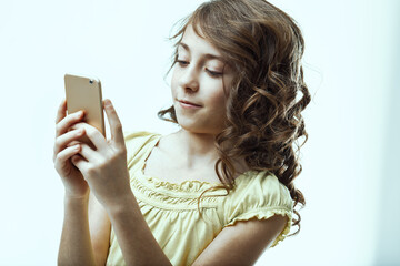 Smiling girl using smartphone on white background