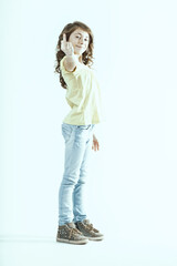 Rebellious preteen girl showing middle finger to the camera