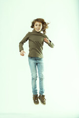Happy girl jumping with enthusiasm on white background