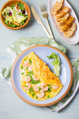 Prawn omelette with peas. Eggs with shrimps. View from above, top studio shot