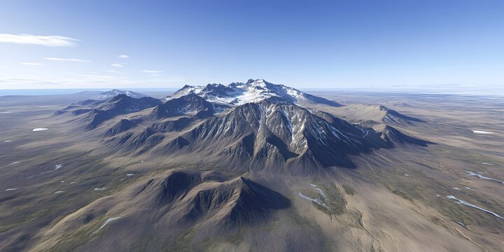 Aerial view of a vast, snow-capped mountain range in a desolate landscape under a clear blue sky.