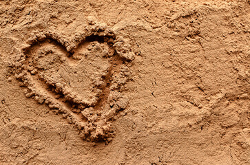 A heart shape on cacao powder.