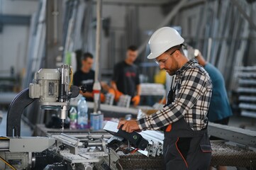 Factory worker. Man with helmet working with pvc