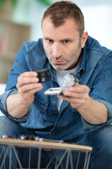man manipulating camera battery and charger
