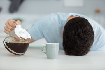 sleepy man with a cup of coffee