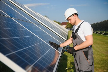 Worker installing solar panels outdoors