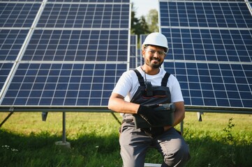 Indian worker installing solar panels. Concept of alternative, renewable energy