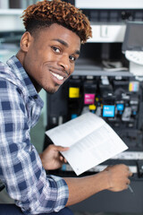 happy man changes the printer cartridge
